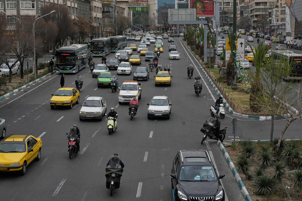 Vehicles drive in downtown Tehran, Iran, Tuesday, Feb. 24, 2026. (AP Photo/Vahid Salemi)