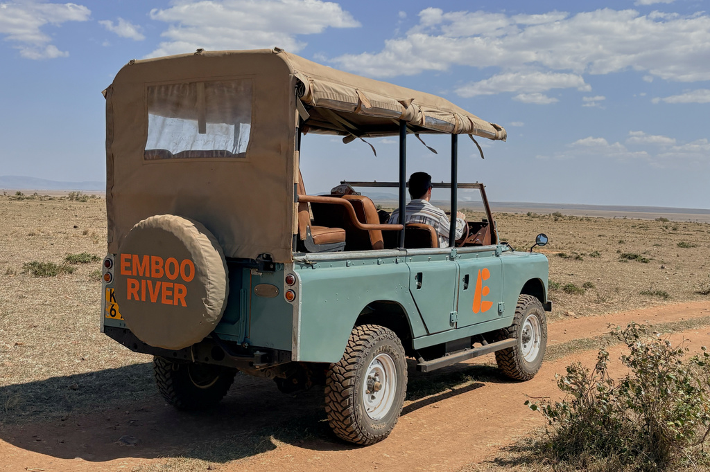 In this photo taken with a smartphone, an electric safari van operated by Emboo Camp drives through the Maasai Mara, Kenya, Saturday, Aug. 29, 2026. (AP Photo/Allan Olingo)