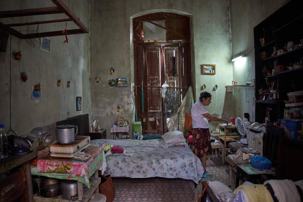 Mercedes Lopez Rey, 83, stands in her one-room apartment in Old Havana, Cuba, Friday, April 10, 2026. (AP Photo/Ramon Espinosa)