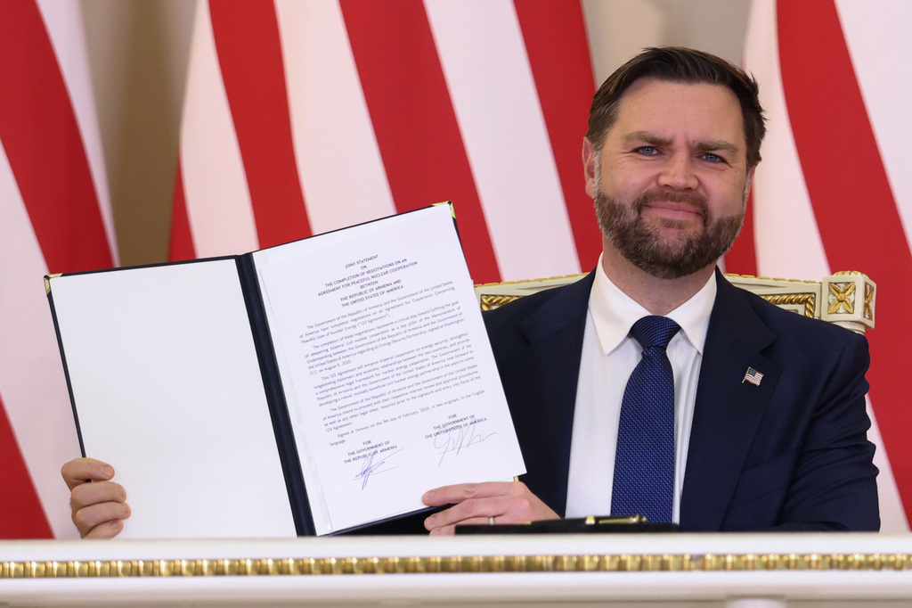 U.S. Vice President JD Vance holds a copy of 'Joint Statement on the Completion of Negotiations on an Agreement for Peaceful Nuclear Cooperation between the United States of America and the Republic of Armenia', which he and Armenia's Prime Minister Nikol Pashinyan signed, at the President's Residence in Yerevan, Armenia, Monday, Feb. 9, 2026. (Kevin Lamarque/Pool Photo via AP)