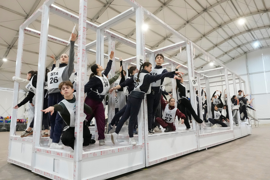 Volunteer dancers perform during rehearsals for the opening ceremony of the Milan Cortina 2026 Winter Olympic Games, at a compound in a big tent next to San Siro Stadium, in Milan, Italy, Saturday, Jan. 24, 2026. (AP Photo/Luca Bruno)