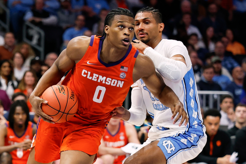 FILE - Clemson forward RJ Godfrey (0) drives to the basket against North Carolina forward Jarin Stevenson during the second half of an NCAA college basketball game in the quarterfinals of the Atlantic Coast Conference tournament in Charlotte, N.C., March 12, 2026. (AP Photo/Nell Redmond, File)