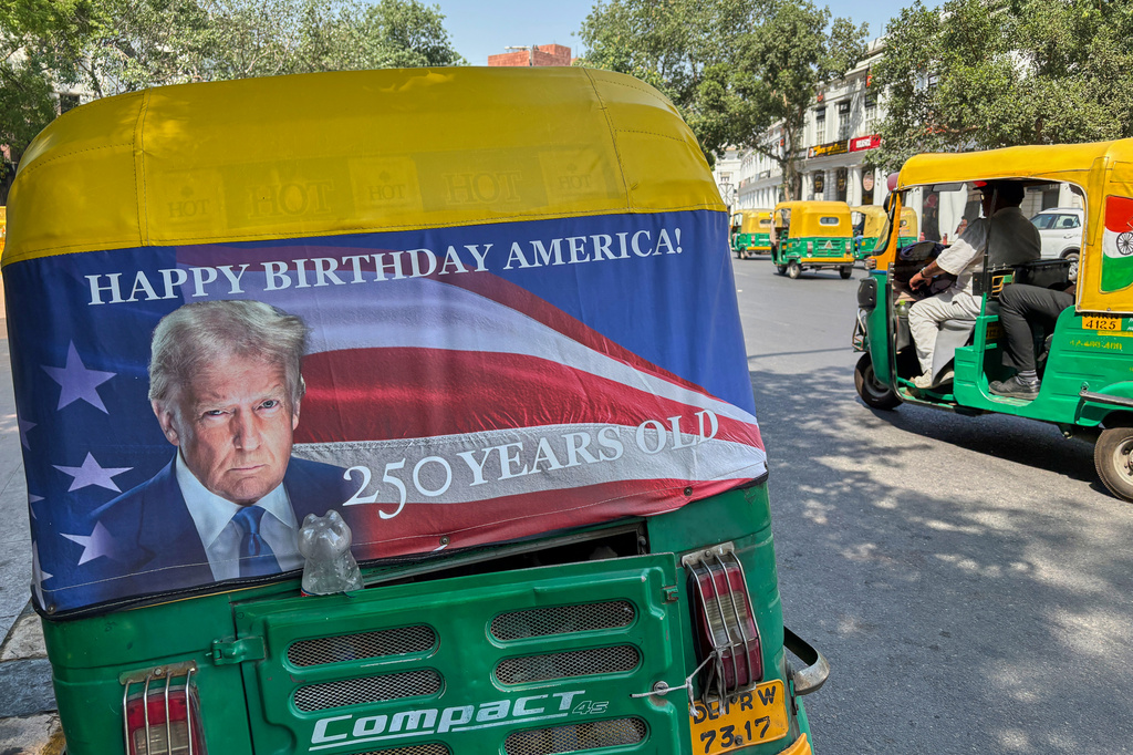 An auto-rickshaw displays a poster of U.S. President Donald Trump that celebrates "250 Years of America" on the back of vehicle in New Delhi, India, Wednesday, May 20, 2026. (AP Photo/Shonal Ganguly)