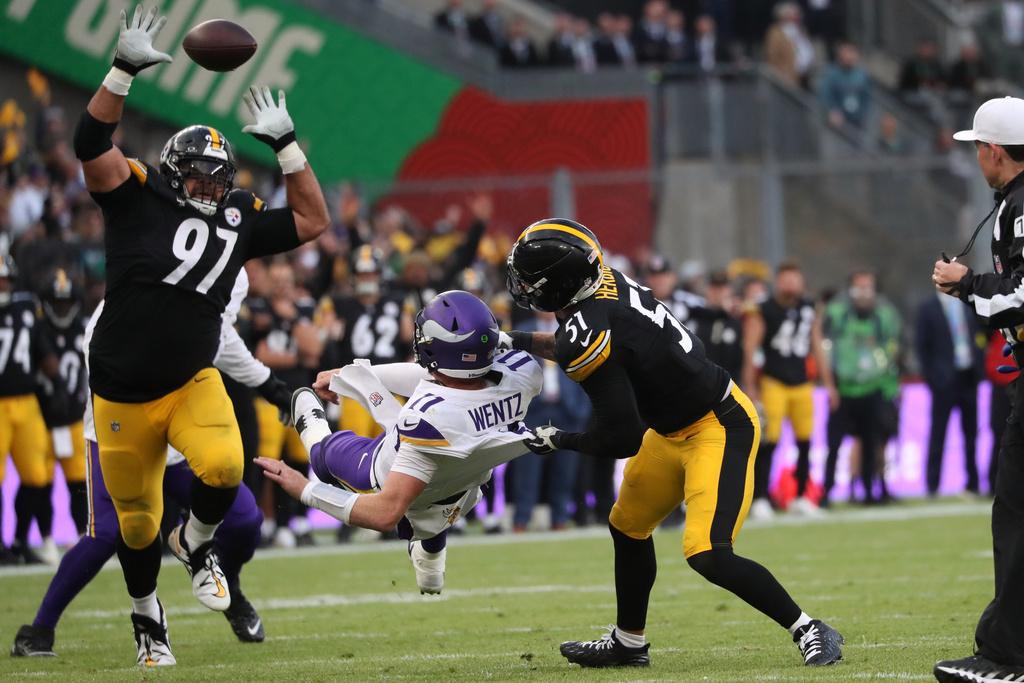 Pittsburgh Steelers defensive tackle Cameron Heyward (97), left, Pittsburgh Steelers linebacker Nick Herbig (51) and Minnesota Vikings quarterback Carson Wentz (11),center, challenge for the ball during the NFL football game between Minnesota Vikings and Pittsburgh Steelers at Croke Park stadium in Dublin, Sunday, Sept. 28, 2025.(AP Photo/Peter Morrison)