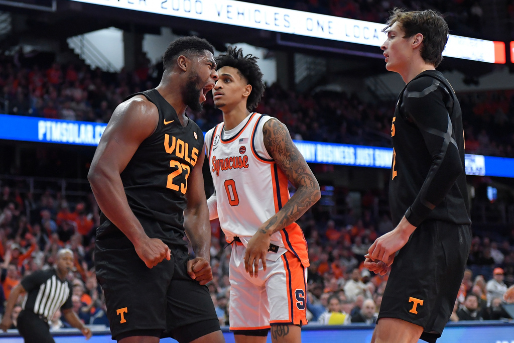 Tennessee forward Jaylen Carey, left, reacts as forward Cade Phillips, right, and Syracuse forward Sadiq White Jr. (0) look on during the first half of an NCAA college basketball game Tuesday, Dec. 2, 2025, in Syracuse, N.Y. (AP Photo/Adrian Kraus)