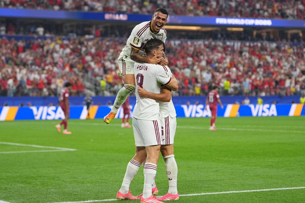 Spain's Pedro Porro, top, congrats Spain's Mikel Merino, right, after scored during the World Cup round of 16 soccer match between Portugal and Spain in Arlington, Texas, near Dallas, Monday, July 6, 2026. (AP Photo/Julio Cortez)