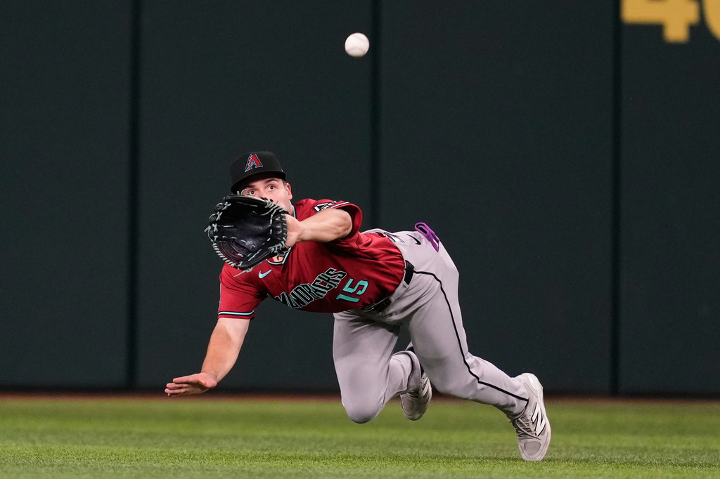 Arizona Diamondbacks center fielder Ryan Waldschmidt makes a diving catch on a Texas Rangers' Jake Burger fly out in the fifth inning of a baseball game Monday, May 11, 2026, in Arlington, Texas. (AP Photo/Tony Gutierrez)