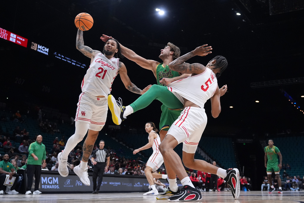 Notre Dame forward Carson Towt, center, battles Houston guard Emanuel Sharp (21) and center Chris Cenac Jr. (5) for a rebound during the second half of an NCAA college basketball game in the Players Era tournament in Las Vegas, Wednesday, Nov. 26, 2025. (AP Photo/Eric Gay)