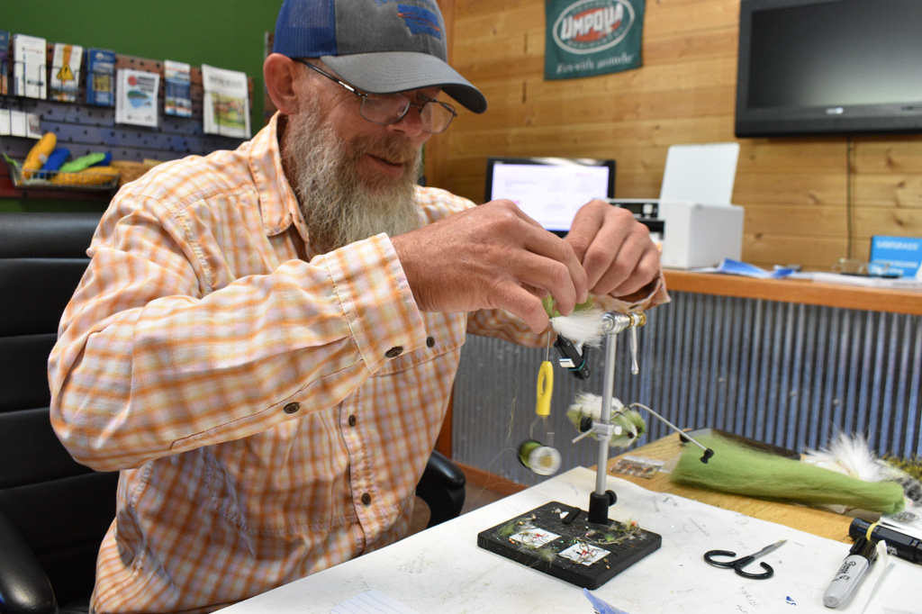 Rich Ridgeway is seen tying a lure at Sweetwater Fly Shop, July 31, 2026, in Livingston, Montana. (AP Photo/Matthew Brown)