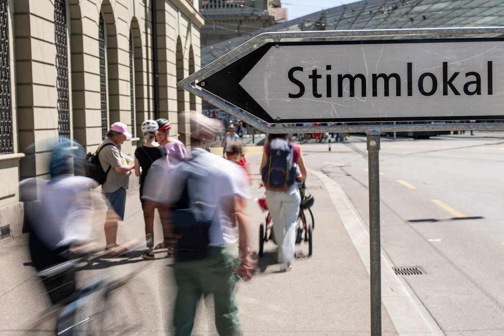 People approach the polling station near the train station on this election Sunday, when voters are deciding on the "No to 10-Million Switzerland" and the Civil Protection Act, on Sunday, June 14, 2026, in Bern. (Alessandro della Valle/Keystone via AP)