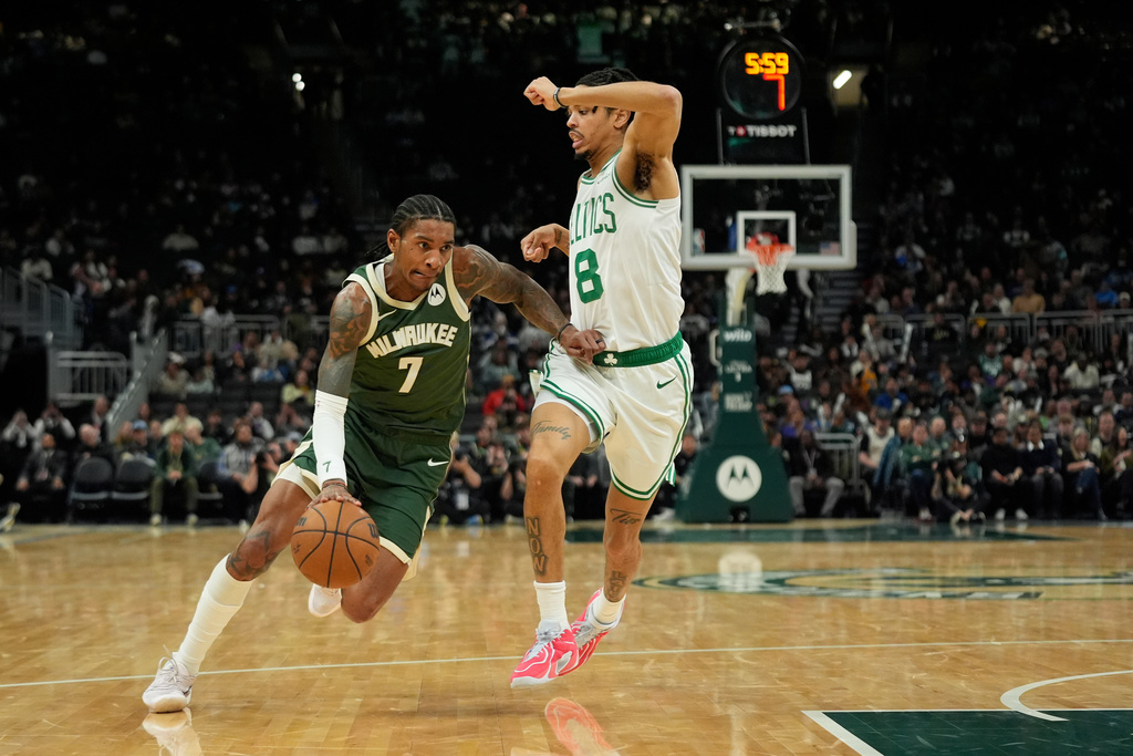 Milwaukee Bucks' Kevin Porter Jr. (7) drives to the basket against Boston Celtics' Josh Minott (8) during the first half of an NBA basketball game Thursday, Dec. 11, 2025, in Milwaukee. (AP Photo/Aaron Gash)