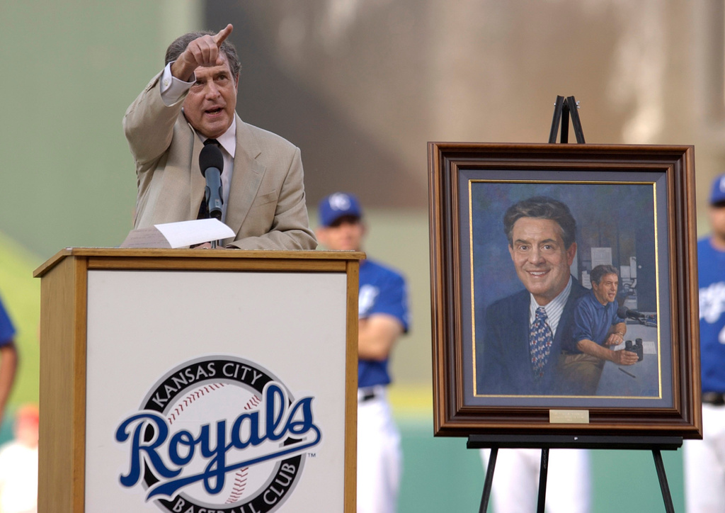 FILE = Denny Hatthews points to the radio booth at Kauffman Stadium as he thanks Ryan Lefebvre during Matthews' induction to the Kansas City Royals' Hall of Fame of Saturday, Aug. 7, 2004, in Kansas City, Mo. (AP Photo/Ed Zurga, File)
