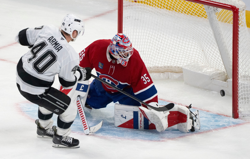 Los Angeles Kings' Joel Armia (40) scores on Montreal Canadiens goaltender Sam Montembeault (35) during third period NHL hockey action in Montreal on Tuesday, Nov. 11, 2025. (Christinne Muschi/The Canadian Press via AP)