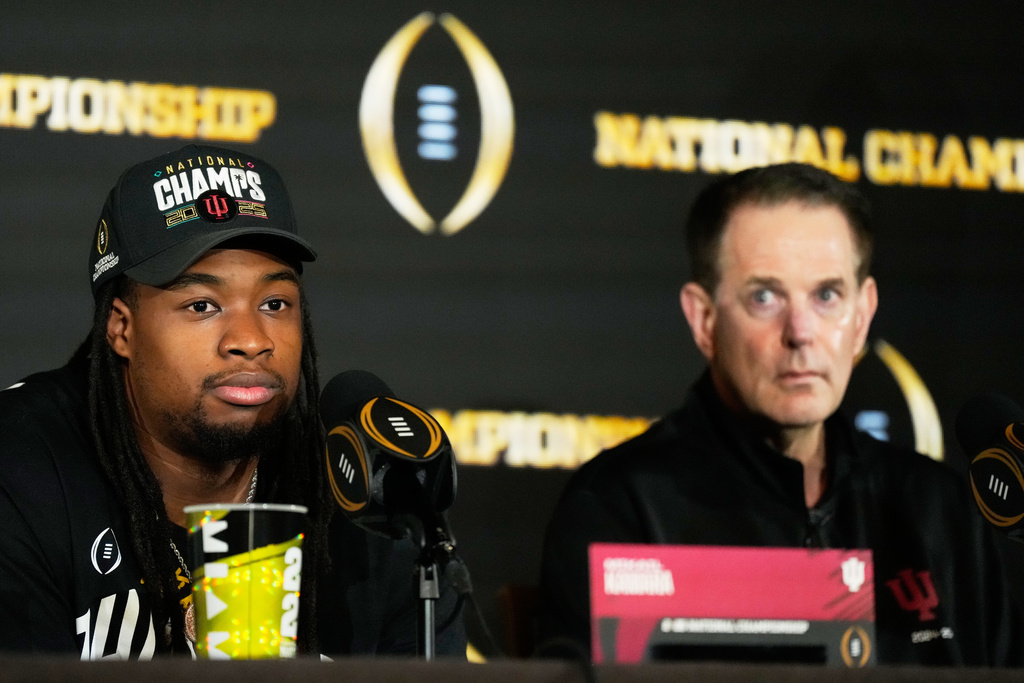 Indiana defensive lineman Mikail Kamara speaks as head coach Curt Cignetti looks on during the champions news conference after theiir win against Miami in the College Football Playoff national championship game, Tuesday, Jan. 20, 2026, in Miami. (AP Photo/Chris Carlson)