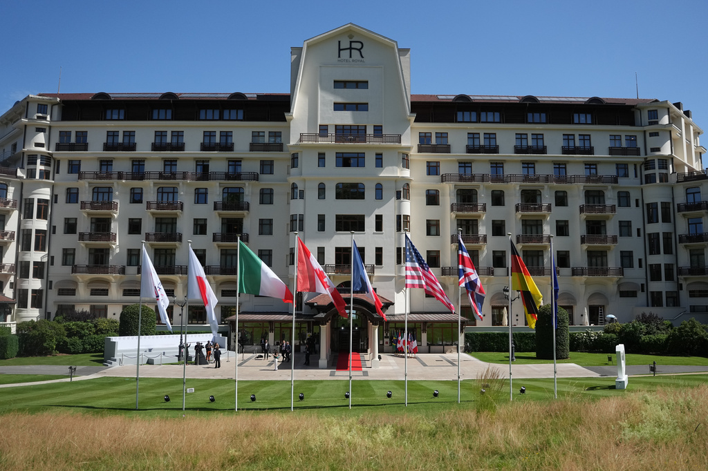 Flags of member nations flap in the wind outside the main venue of the G7 summit in Evian-les-Bains, France, Monday, June 15, 2026. (AP Photo/Thibault Camus)