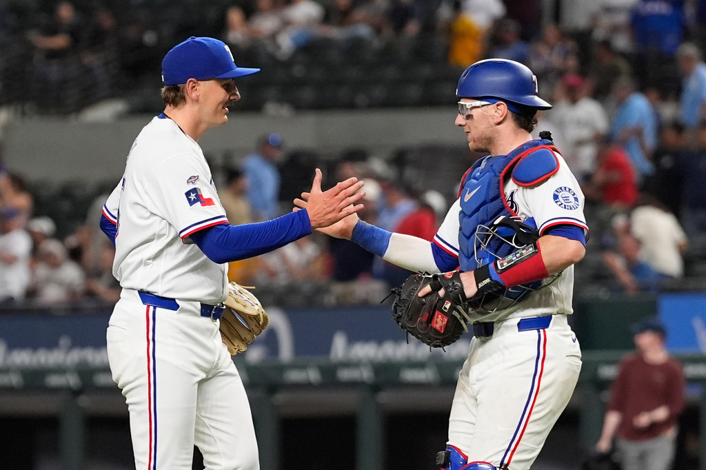 Texas Rangers relief pitcher Peyton Gray, left, celebrates with catcher Danny Jansen, right, after the team's win in a baseball game against the Pittsburgh Pirates Thursday, April 23, 2026, in Arlington, Texas. (AP Photo/Tony Gutierrez)