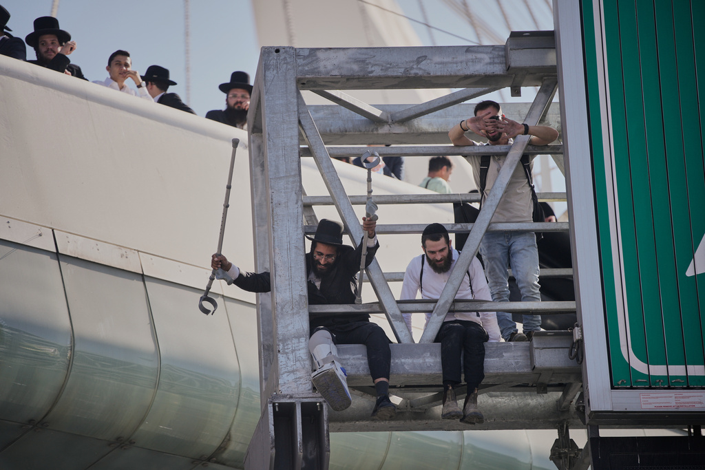 Ultra-Orthodox Jews gather for a protest against plans to force them to serve in the Israeli military, in Jerusalem, Thursday, Oct. 30, 2025. (AP Photo/Ohad Zwigenberg)