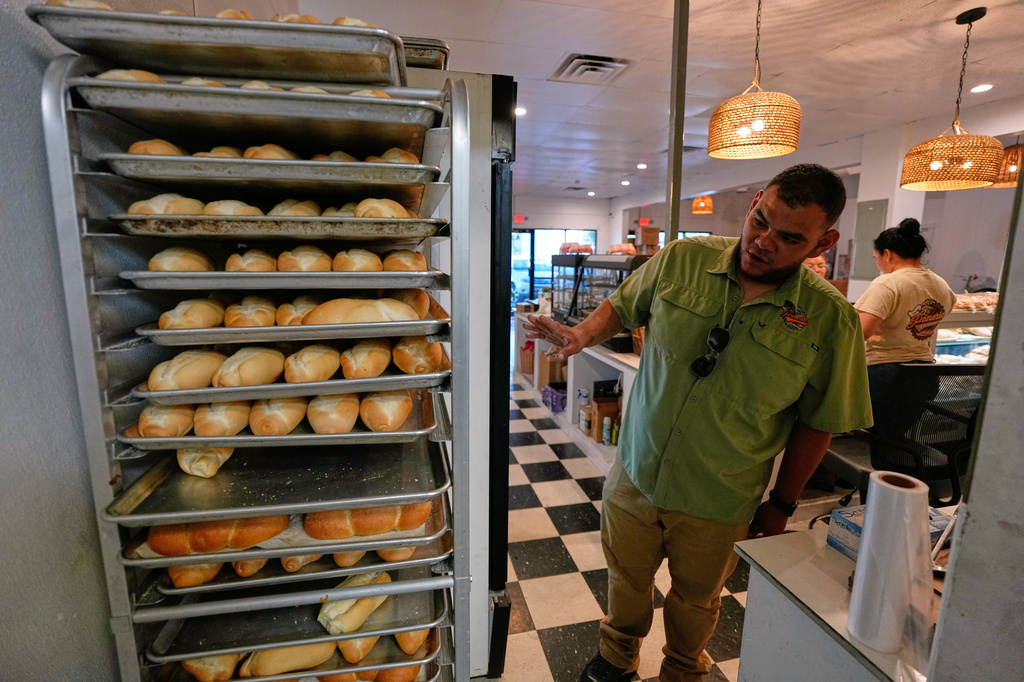 Venezuelan Enrique Vera works in his bakery, which offers Venezuelan baked goods, Wednesday, July 15, 2026, in West Valley City, Utah. (AP Photo/Gregory Bull)