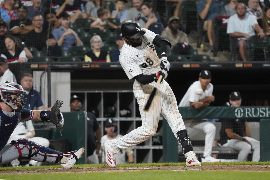 Chicago White Sox' Luis Robert Jr. hits a home run against the Minnesota Twins during the eighth inning of a baseball game Saturday, August 23, 2025, in Chicago. (AP Photo/David Banks)