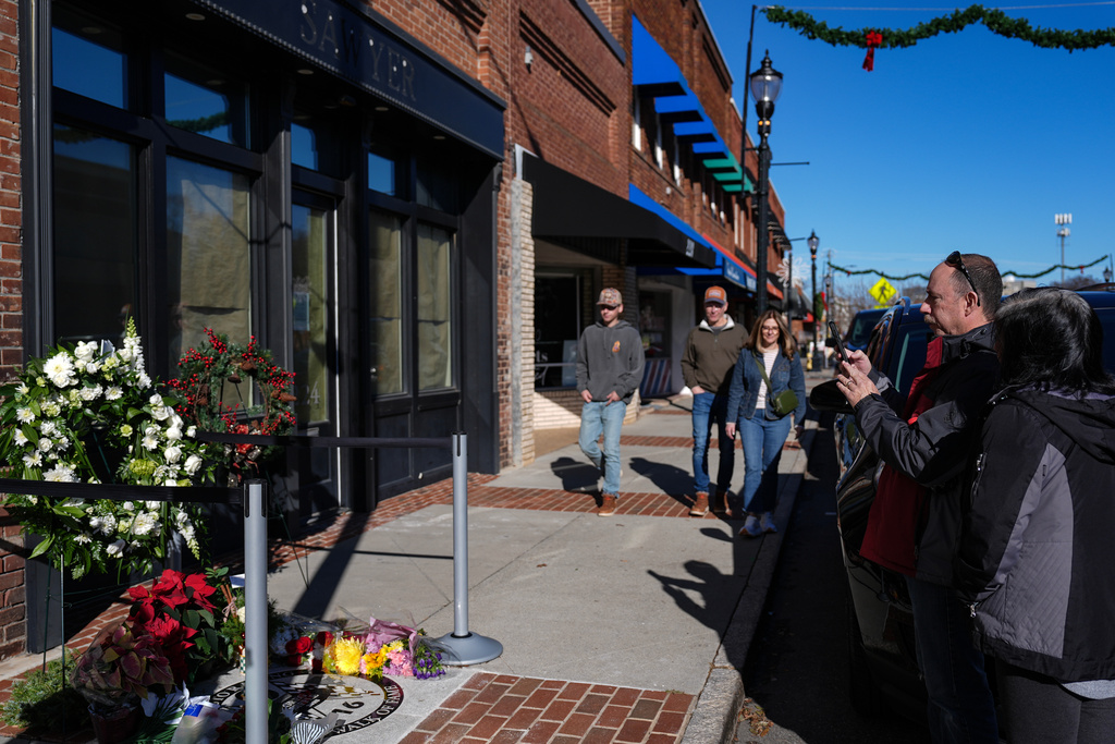 Supporters gather at the tribute next to the NC Auto Racing Walk of Fame for Greg Biffle, Friday, Dec. 19, 2025, in Mooresville, N.C. (AP Photo/Matt Kelley)
