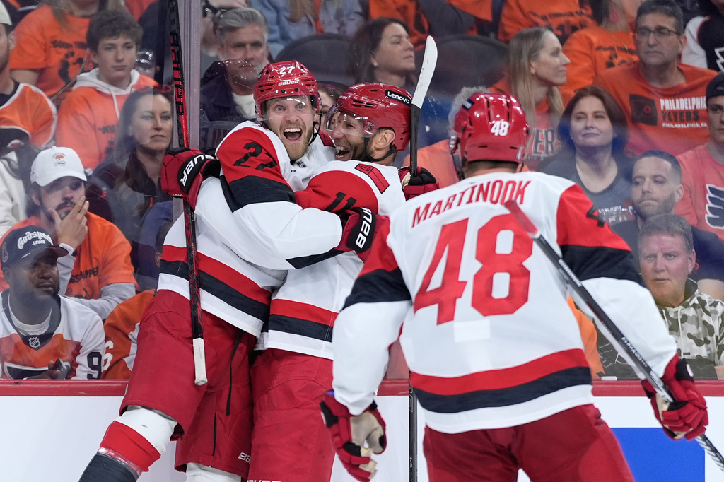 Carolina Hurricanes' Nikolaj Ehlers, from left, Jordan Staal and Jordan Martinook celebrate after a goal by Ehlers during the third period of Game 3 in the second round of the NHL hockey Stanley Cup playoffs against the Philadelphia Flyers Thursday, May 7, 2026, in Philadelphia. (AP Photo/Matt Slocum)