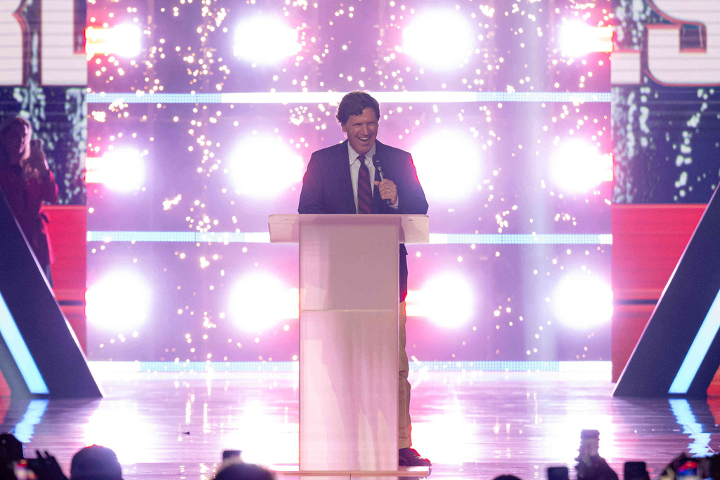 Tucker Carlson speaks during Turning Point USA's AmericaFest 2025, Thursday, Dec. 18, 2025, in Phoenix. (AP Photo/Jon Cherry)