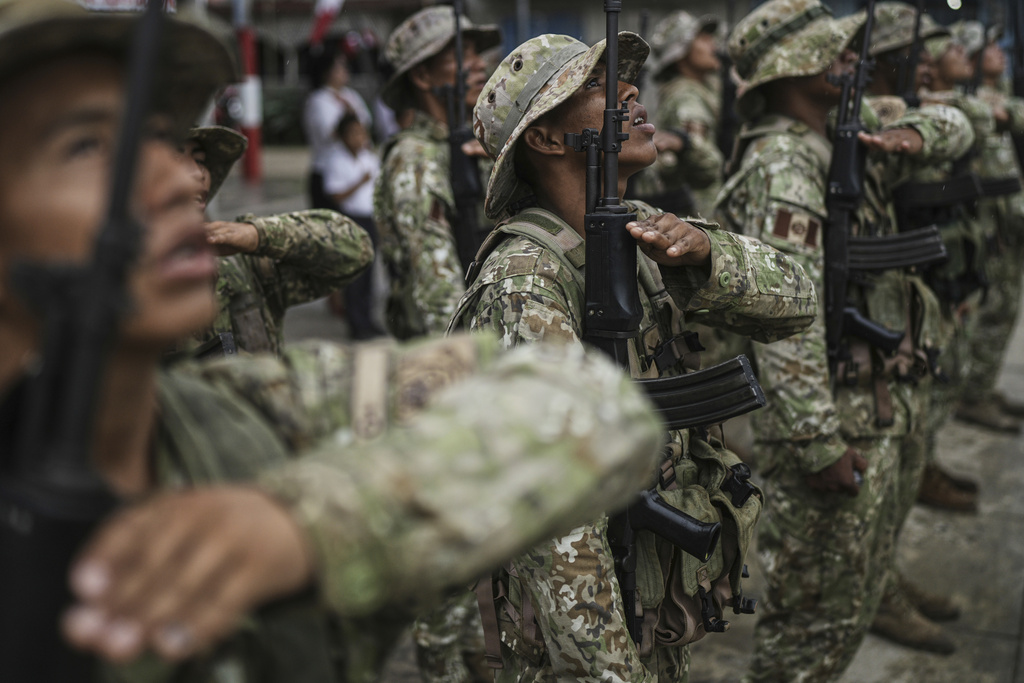 Peruvian soldiers form ranks during a flag ceremony in Santa Rosa, Peru, an island on the Amazon River at the center of a territorial dispute with Colombia, Sunday, Aug. 17, 2025. (AP Photo/Ivan Valencia)