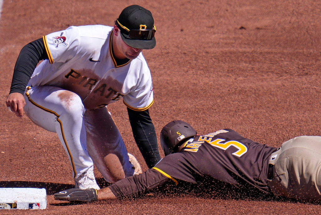 San Diego Padres' Ramón Laureano (5) gets into third ahead of the tag by Pittsburgh Pirates third baseman Nick Yorke during the sixth inning of a baseball game in Pittsburgh, Wednesday, April 8, 2026. (AP Photo/Gene J. Puskar)