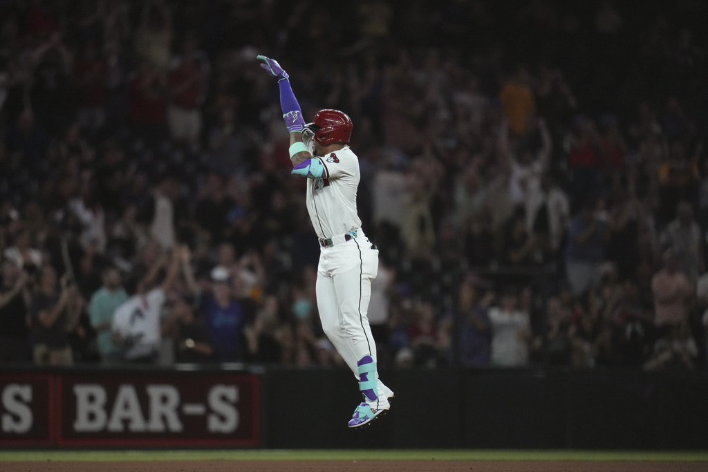 Arizona Diamondbacks' Ketel Marte celebrates his three-run home run against the Texas Rangers during the seventh inning of a baseball game Tuesday, Sept. 2, 2025, in Phoenix. (AP Photo/Ross D. Franklin)