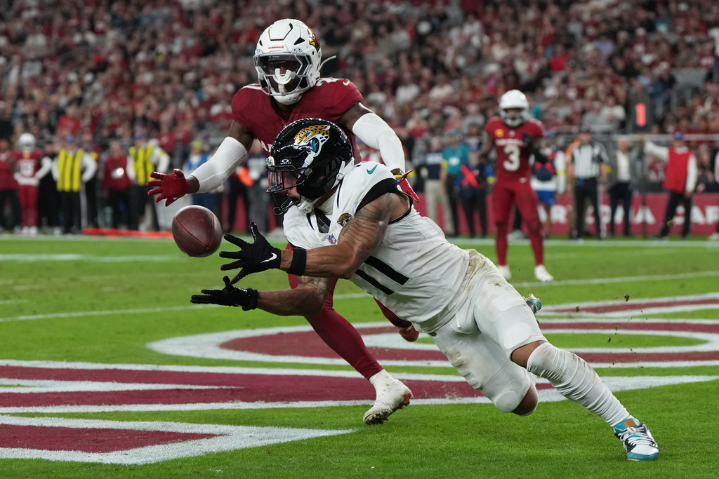 Jacksonville Jaguars wide receiver Parker Washington (11) catches a pass for a touchdown during the second half of an NFL football game against the Arizona Cardinals Sunday, Nov. 23, 2025, in Glendale, Ariz. (AP Photo/Rick Scuteri)