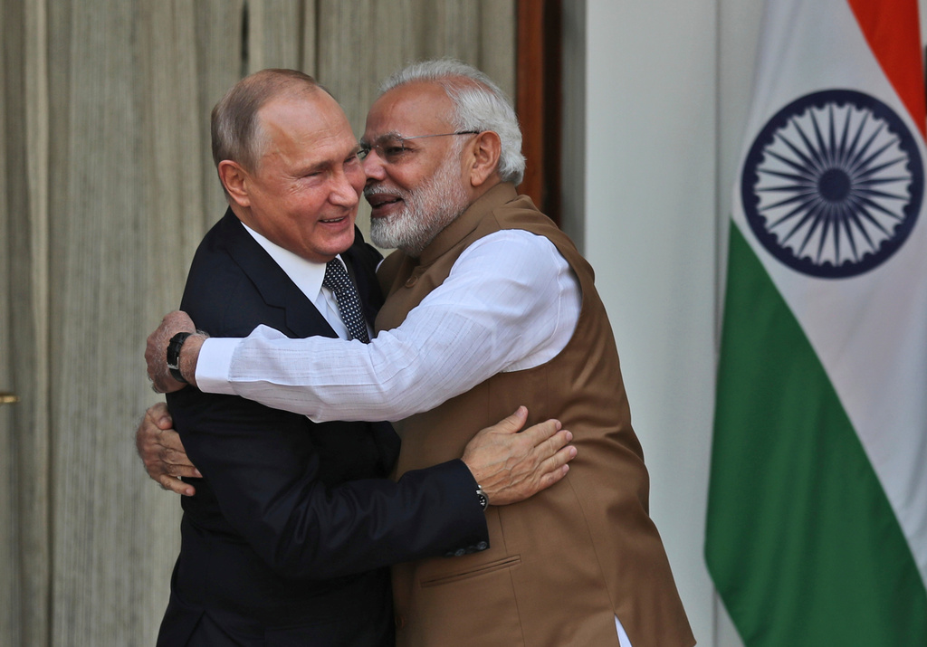 FILE - Indian Prime Minister Narendra Modi, right, hugs Russian President Vladimir Putin before their meeting in New Delhi, India, on Oct. 5, 2018. (AP Photo/Manish Swarup, File)