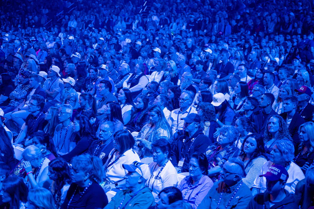 Attendees sit during Turning Point USA's AmericaFest 2025, Thursday, Dec. 18, 2025, in Phoenix. (AP Photo/Jon Cherry)