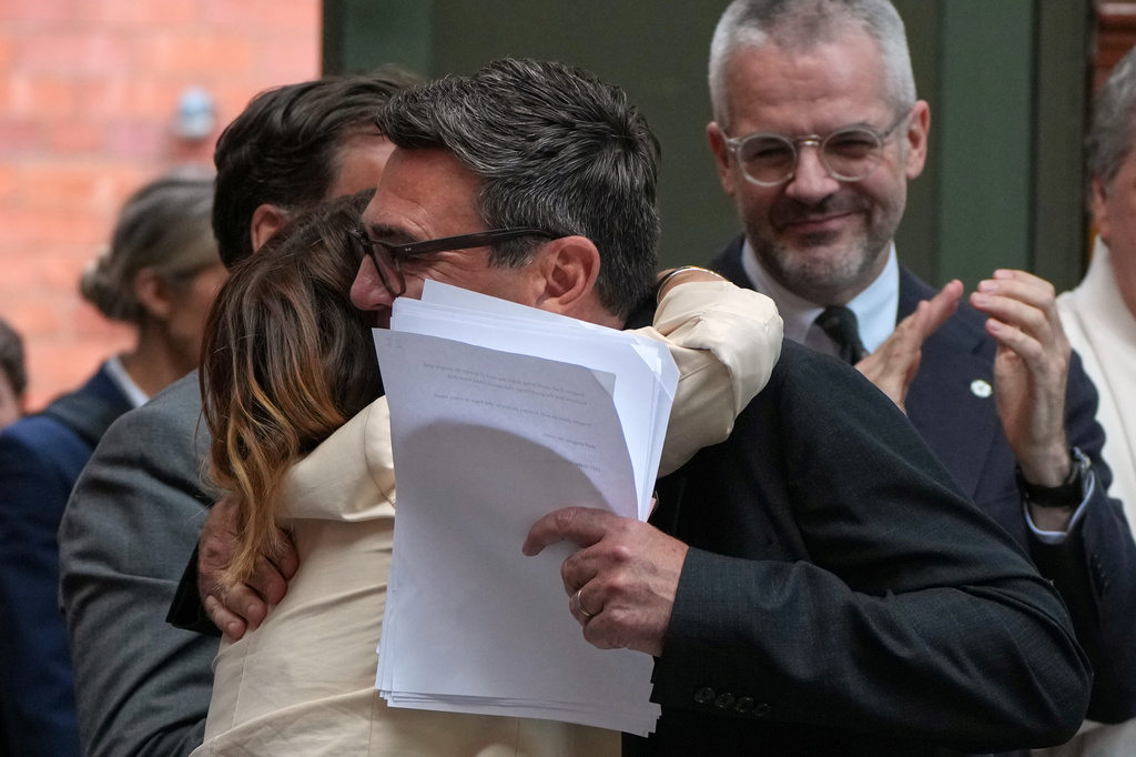 Labour Party's Andy Burnham is hugged by party members before he delivers a speech at the People's History Museum in Manchester, England, Monday, June 29, 2026.(AP Photo/Alastair Grant)