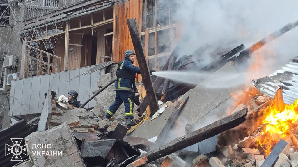 In this photo, provided by the Ukrainian Emergency Service, emergency services personnel work to extinguish a fire following a Russian missile attack in Kharkiv, Ukraine, Friday, Jan. 2, 2026. (Ukrainian Emergency Service via AP)