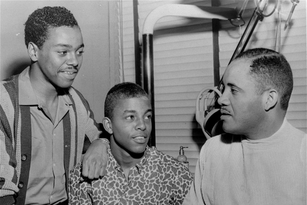 FILE - Joseph McNeil, left, stands next to Ezell Blair, Jr., center, student leader in the original lunch counter sit-down demonstration, discussed legal aspects of anti-segregation with Dr. George C. Simkins, right, Greensboro dentist and local NAACP leader, in Greensboro, N.C., April 20, 1960. (News & Record via AP, File)