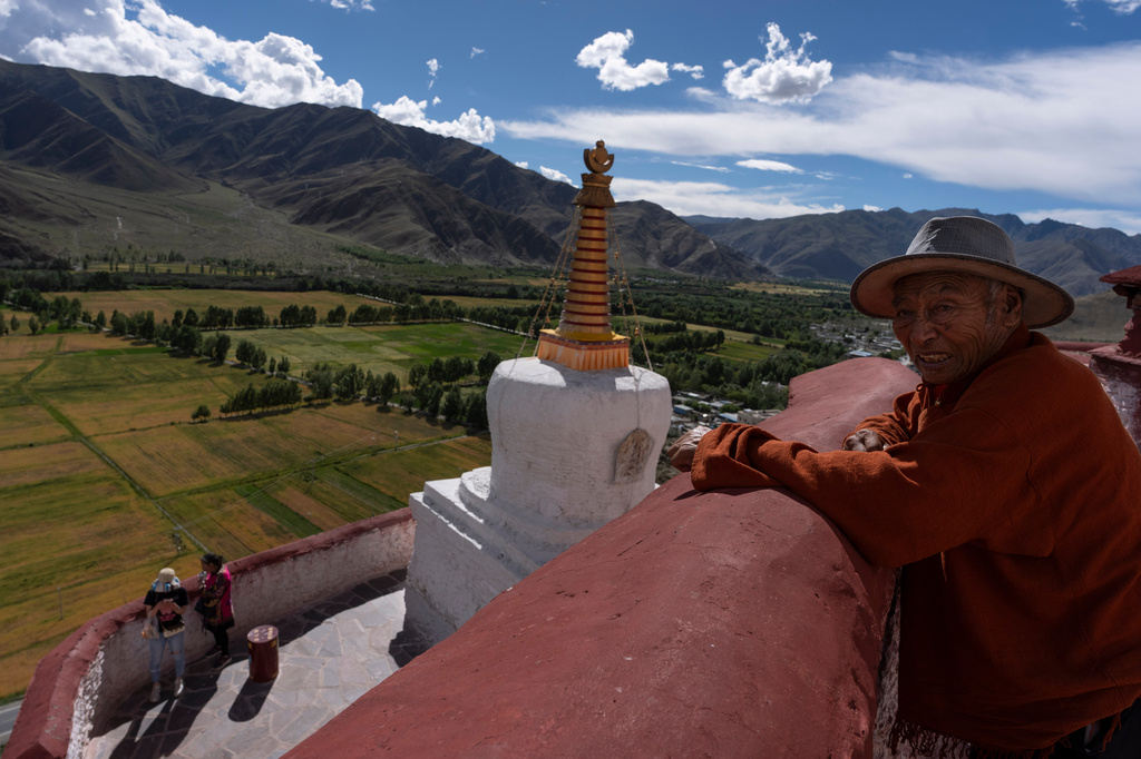 An elderly man looks out from Yumbulagang Palace, regarded as Tibet's first palace, in Shannan in western China's Tibet Autonomous Region on Thursday, July 23, 2026, as seen during a government organized visit for foreign journalists. (AP Photo/Ng Han Guan)