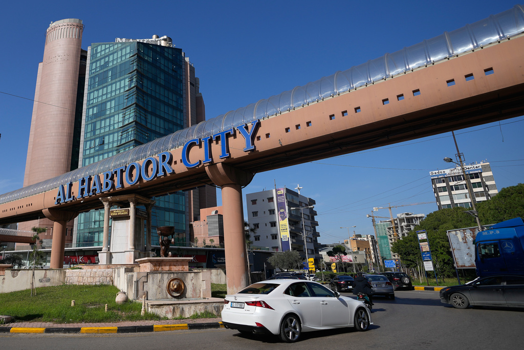 Cars pass next to Habtoor hotel, left, in Beirut, Lebanon, Monday, Jan. 26, 2026. (AP Photo/Hassan Ammar)