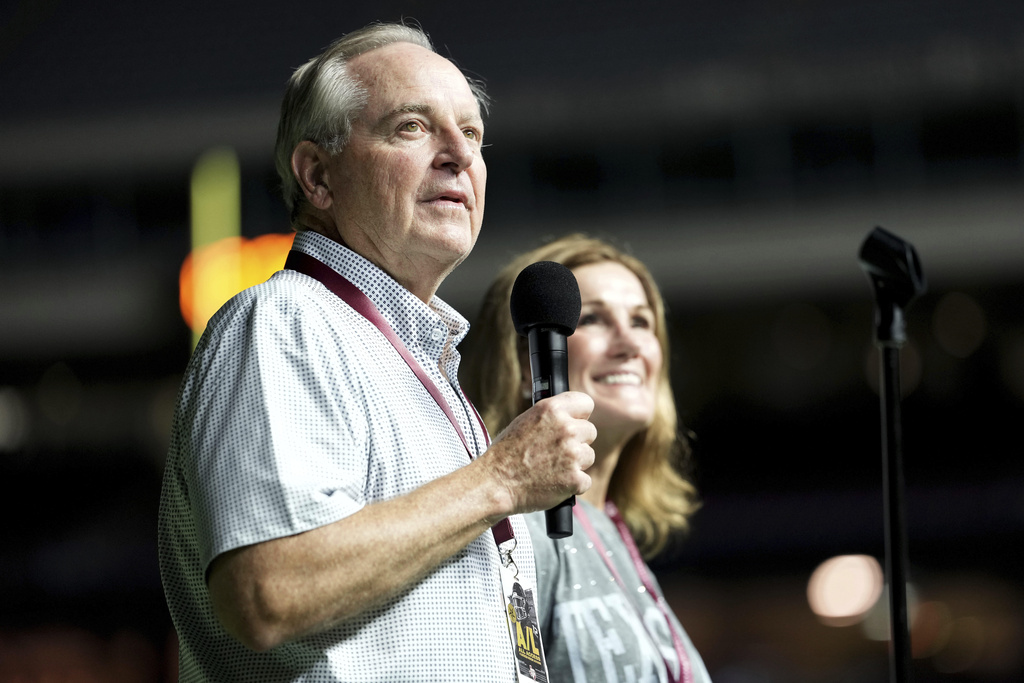 Texas A&M University President Mark A. Welsh, left, addresses the crowd inside Kyle Field as his wife Betty looks on during Midnight Yell in College Station, Texas, Saturday, Aug. 30, 2025. (AP Photo/Sam Craft, File)