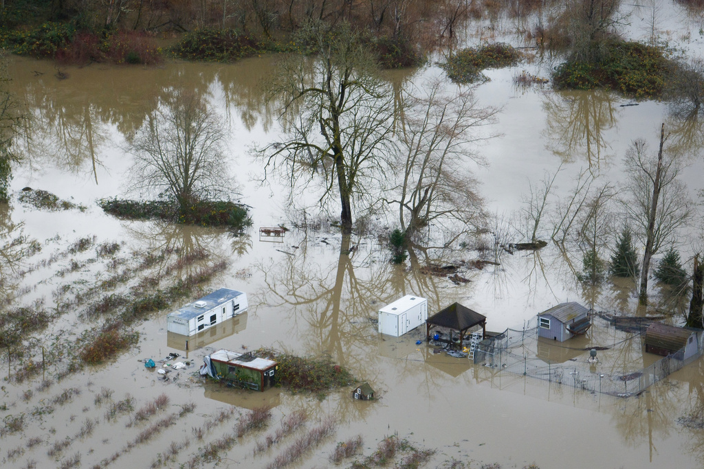 A property with a mobile home is flooded by the Snoqualmie River, near Fall City, Wash., Tuesday, Dec. 9, 2025. (Ken Lambert/The Seattle Times via AP)