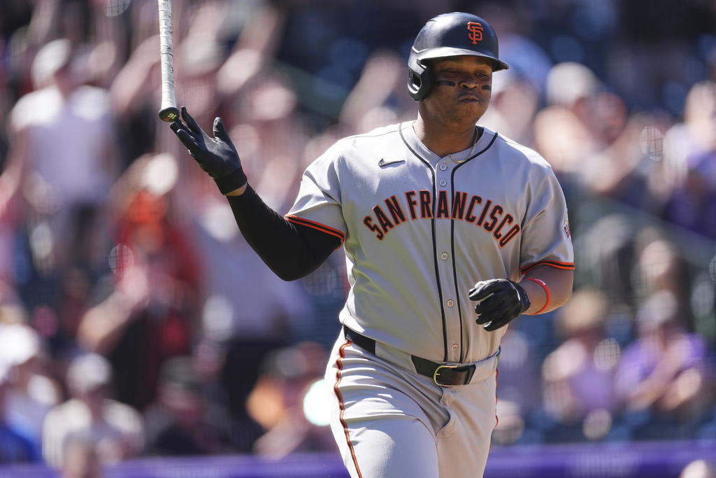 San Francisco Giants' Rafael Devers tosses his bat as he heads up the first base line after hitting a solo home run off Colorado Rockies starting pitcher Chase Dollander in the first inning of a baseball game Monday, Sept. 1, 2025, in Denver. (AP Photo/David Zalubowski)
