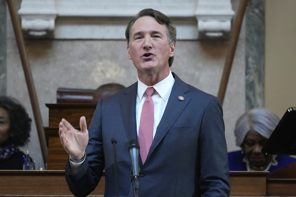 FILE - Virginia Gov. Glenn Youngkin gestures as he delivers his annual State of the Commonwealth address before a joint session of the Virginia General Assembly at the state Capitol, Jan. 13, 2025, in Richmond, Va. (AP Photo/Steve Helber, File)