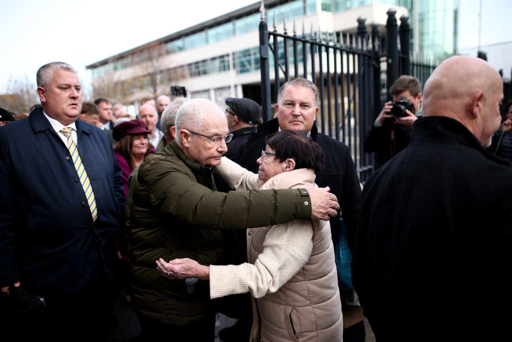 Mickey McKinney, who lost his brother William McKinney in the 1972 Bloody Sunday massacre is comforted outside Belfast Crown Court following the not guilty verdict of British soldier known as Soldier F, Belfast, Northern Ireland, Thursday, Oct. 23, 2025. (AP Photo/Peter Morrison)