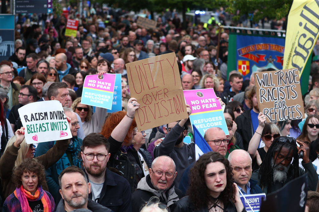 People gather during an anti-racism rally outside Belfast City Hall sparked by a knife attack on a man in north Belfast on Monday, in Belfast, Saturday June 13, 2026. (Peter Morrison/PA via AP)