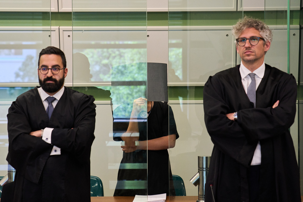 The defendant covering his face in the court during a trial against an online predator network of men accused of using chat groups to share tips on how to drug and rape women, in Berlin, Germany, Wednesday, July 8, 2026. (AP Photo/Ebrahim Noroozi)