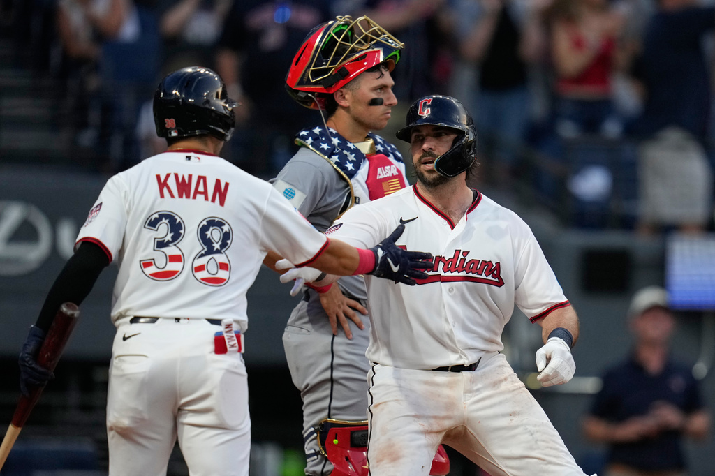 Cleveland Guardians' Austin Hedges, right, celebrates with Steven Kwan (38) in front of Chicago White Sox catcher Drew Romo after hitting a home run in the fifth inning of a baseball game in Cleveland, Saturday, July 4, 2026. (AP Photo/Sue Ogrocki)