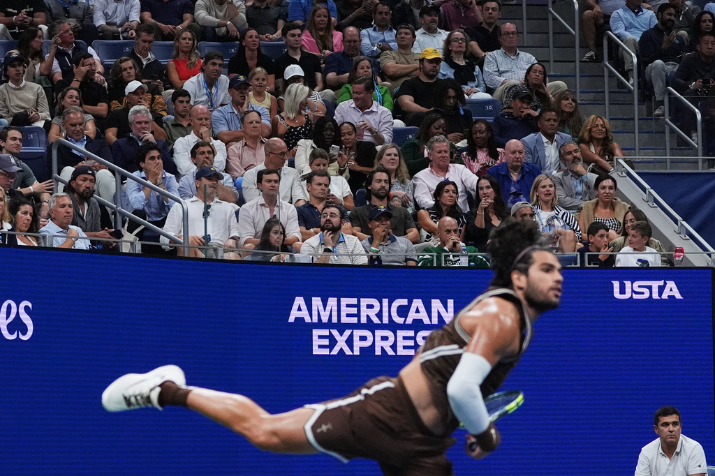 Fans watch as Carlos Alcaraz, of Spain, serves to Jaime Faria, of Portugal, during the second round of the U.S. Open tennis championships, Wednesday, Sept. 2, 2026, in New York. (AP Photo/Sydney Schaefer)