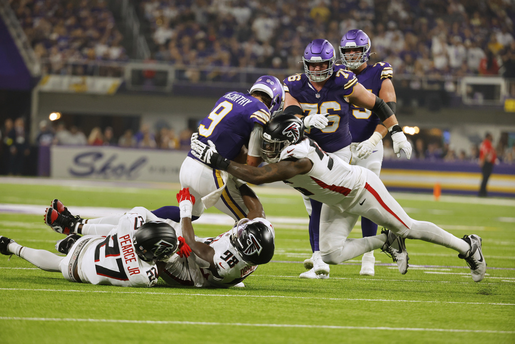 Atlanta Falcons defensive end Zach Harrison (96) sacks Minnesota Vikings quarterback J.J. McCarthy (9) during the first half of an NFL football game, Sunday, Sept. 14, 2025, in Minneapolis. (AP Photo/Bruce Kluckhohn)