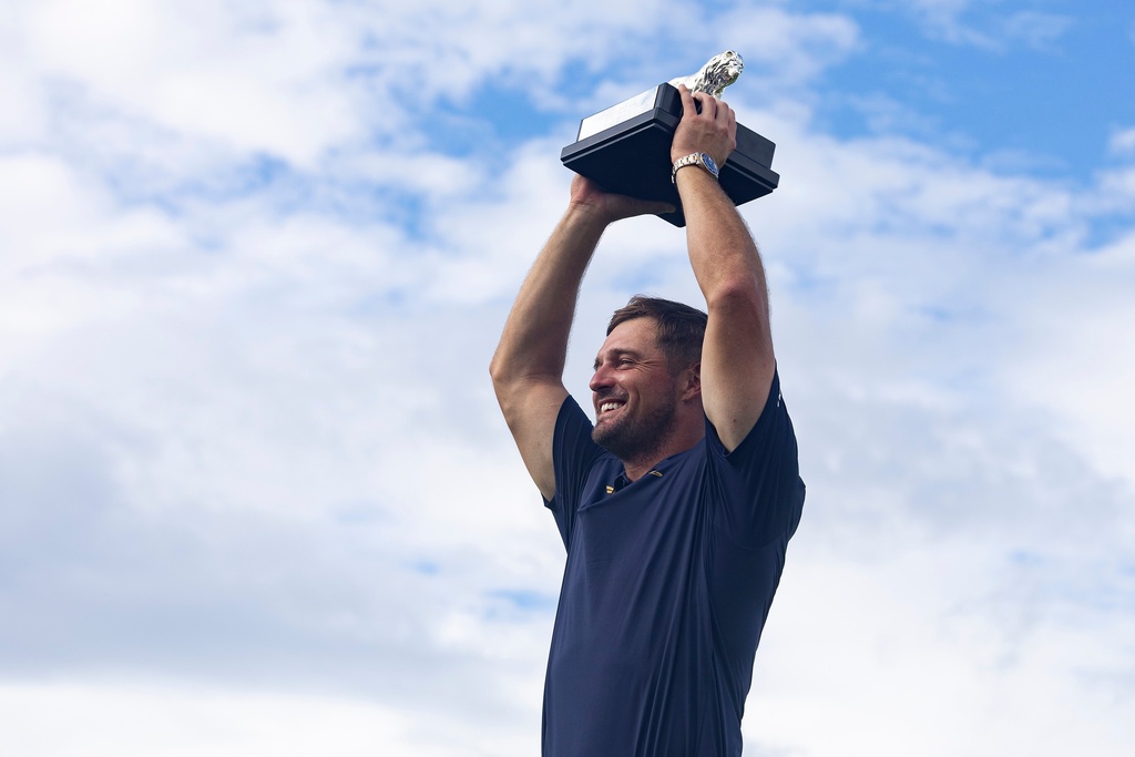 First-place individual champion, captain Bryson DeChambeau, of Crushers GC, poses for a photo with the trophy after the final round of LIV Golf South Africa at The Club at Steyn City, Sunday, March 22, 2026, in Midrand, South Africa. (LIV Golf via AP)
