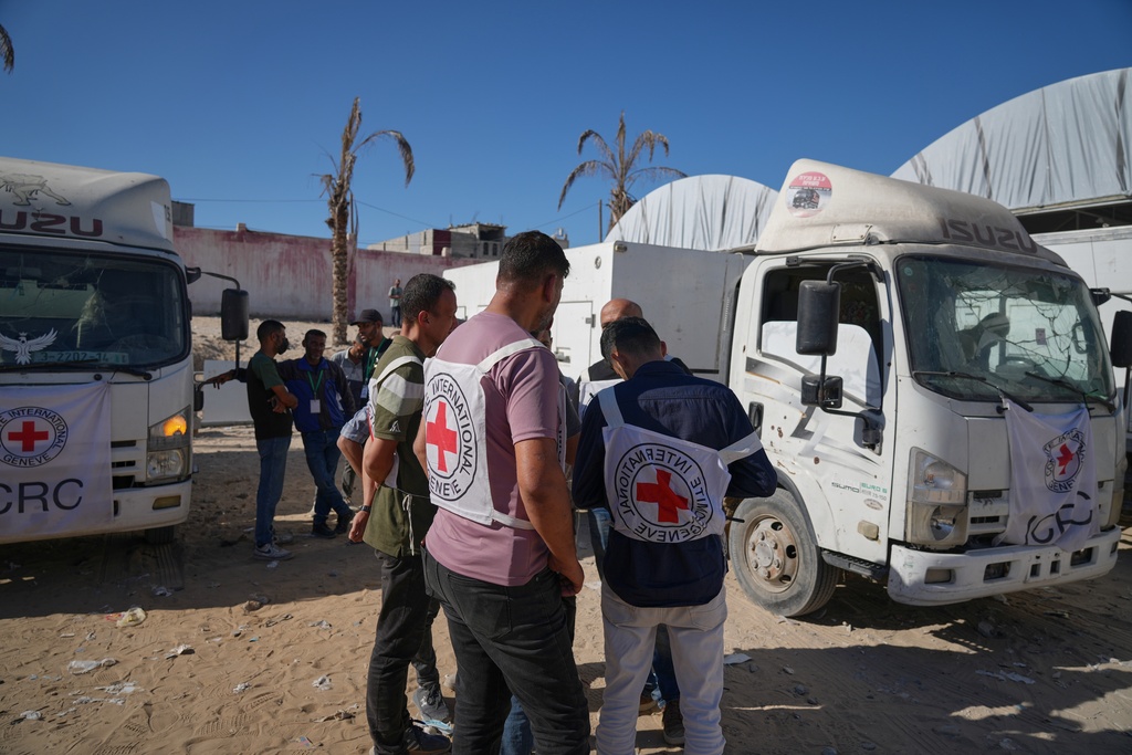 Red Cross vehicles carrying the bodies of deceased Palestinians held by Israel during the war arrive after their release, at the Nasser Hospital in Khan Younis, southern Gaza Strip, Wednesday, Oct. 15, 2025. (AP Photo/Jehad Alshrafi)