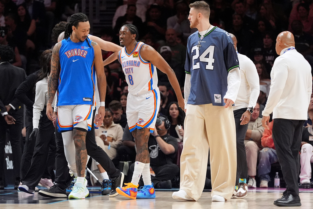 Oklahoma City Thunder guard Jalen Williams (8) limps off the court after sustaining an injury during the first half of an NBA basketball game against the Miami Heat, Saturday, Jan. 17, 2026, in Miami. (AP Photo/Rebecca Blackwell)